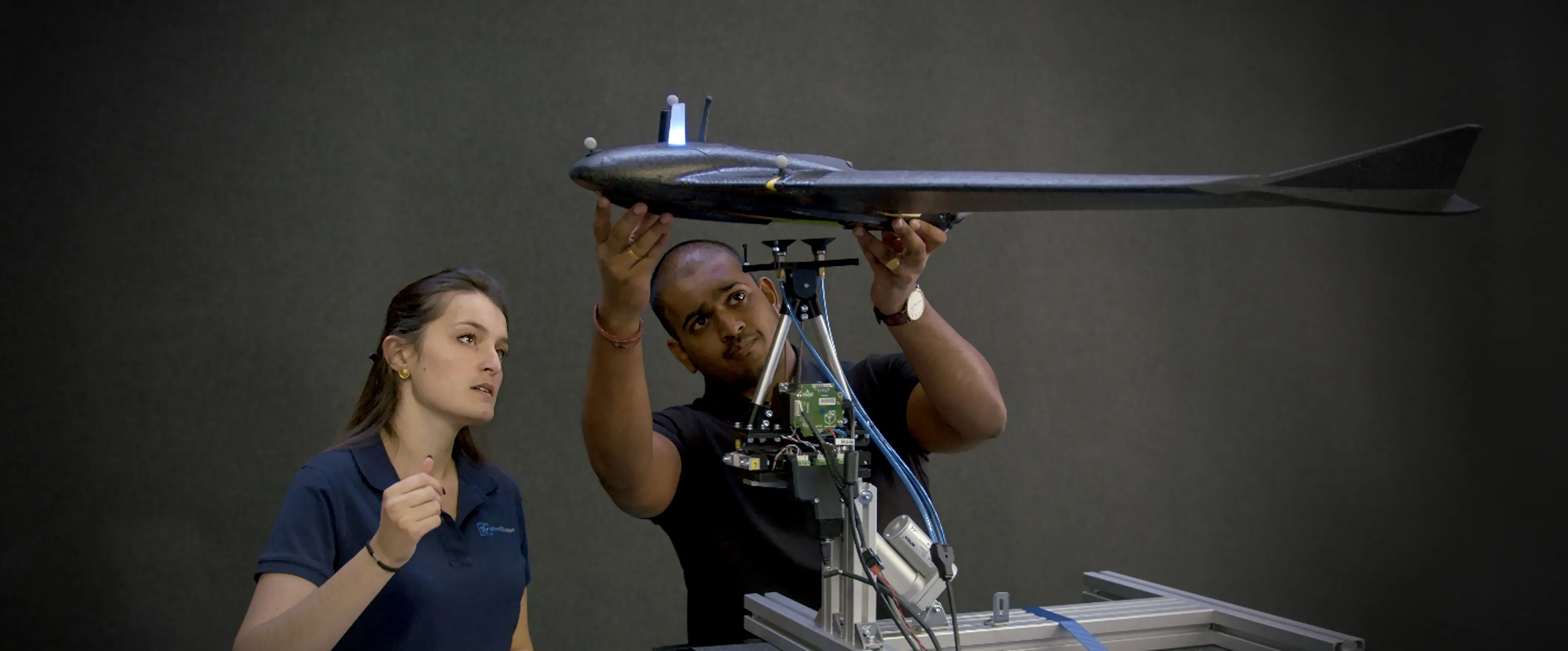 Fixed wing drone being prepared for a free flight test in a WindhSaper laboratory environment.